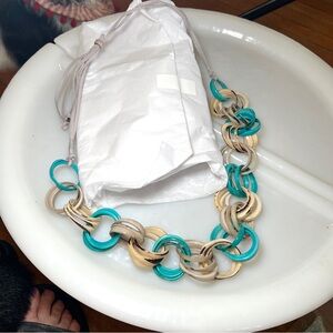 NECKLACE turquoise and bone acrylic rings on taupe leather cord.